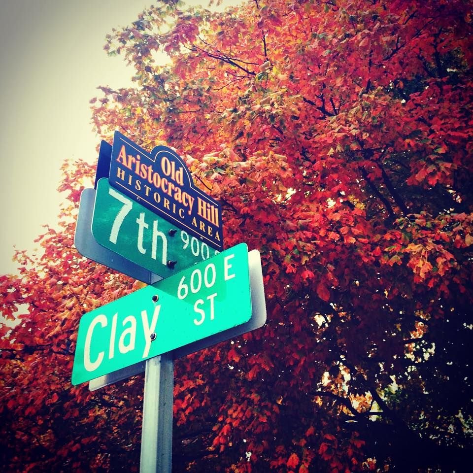 The 7th and Clay street sign in autumn