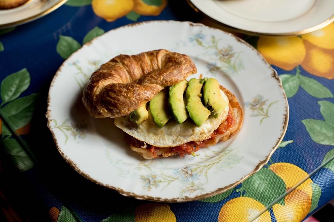 A handmade croissant breakfast sandwich
